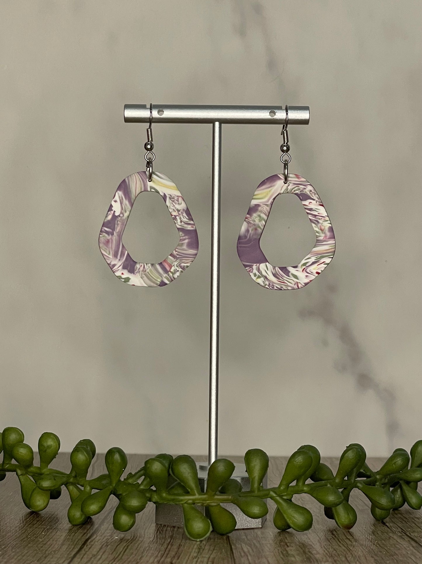 Purple swirled peep through dangle earrings