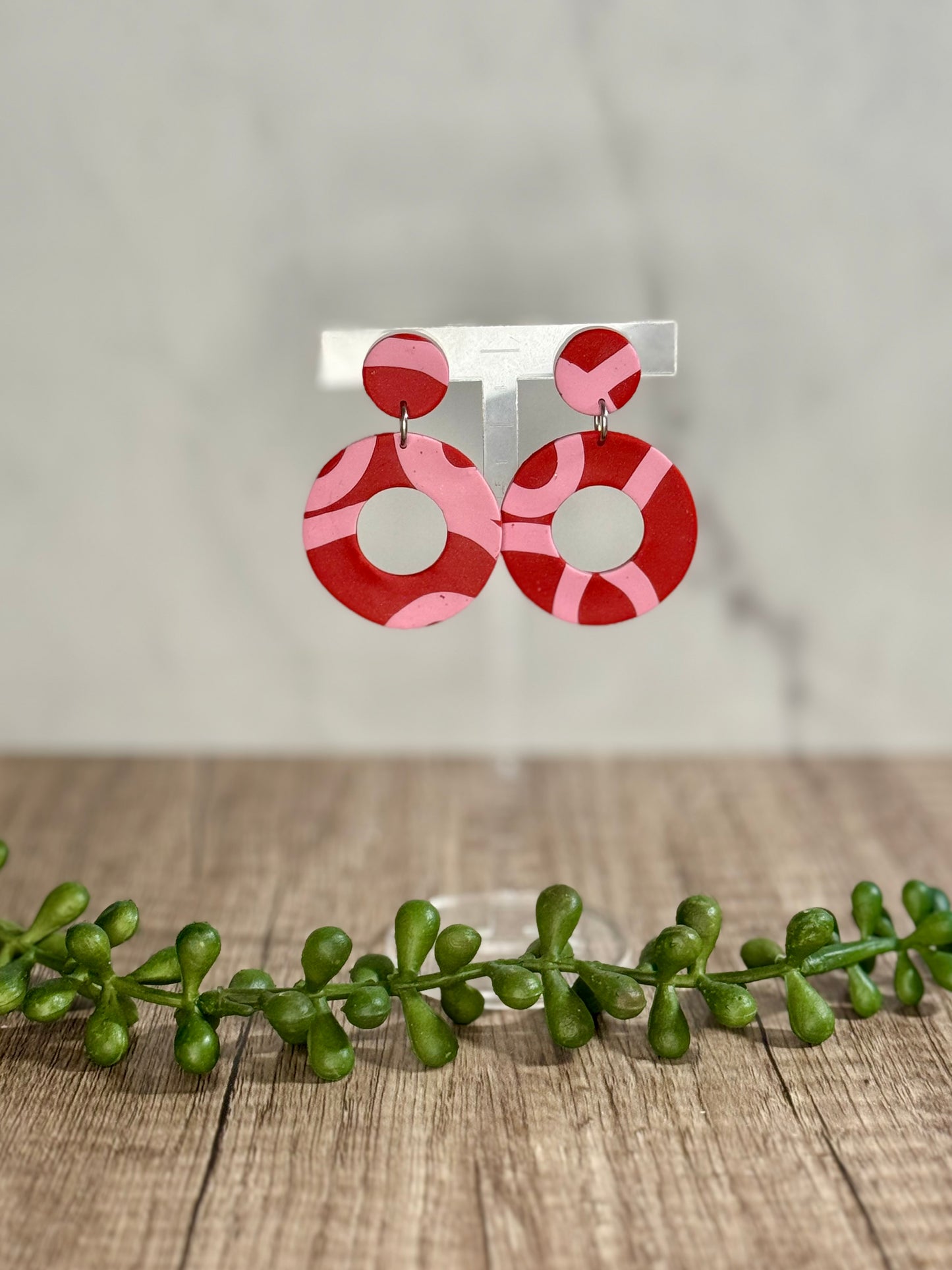 Pink ribbon on red earrings