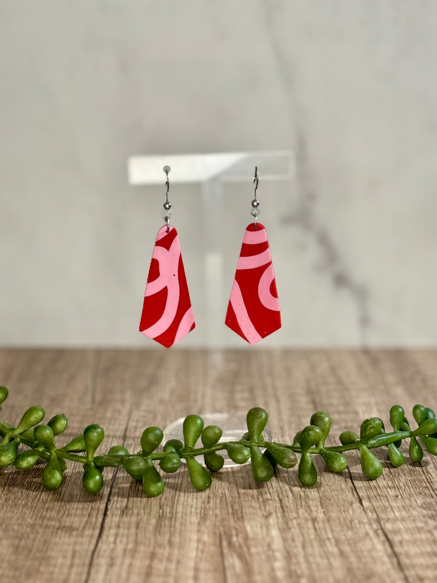 Pink ribbon on red earrings