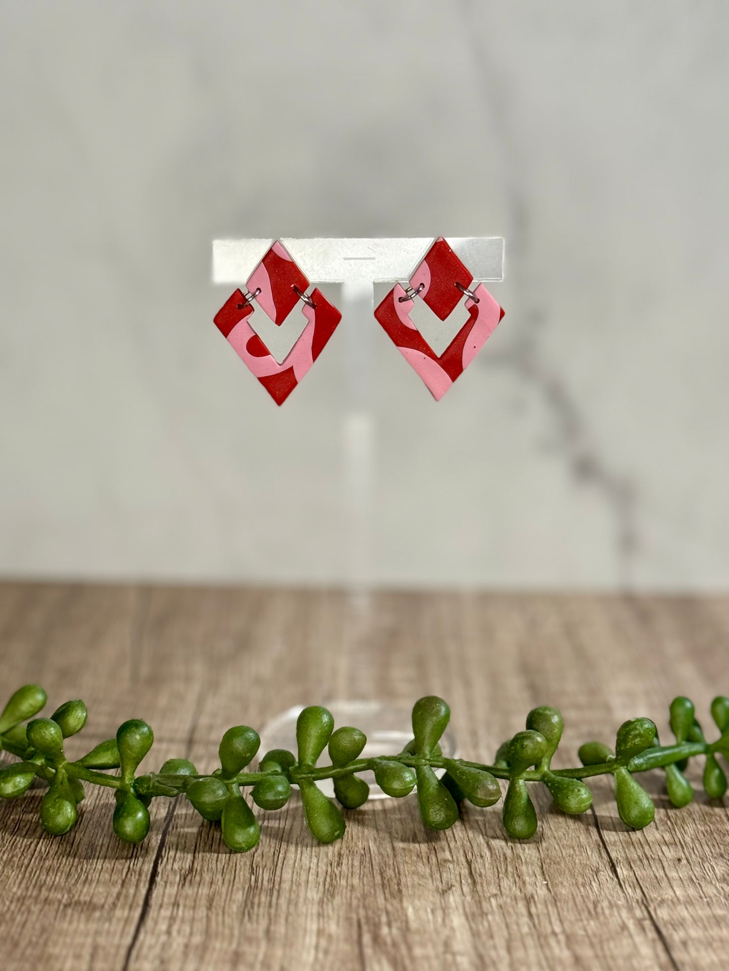 Pink ribbon on red earrings