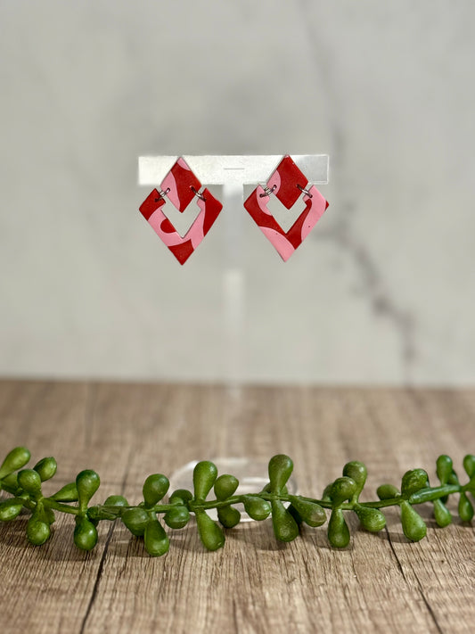 Pink ribbon on red earrings