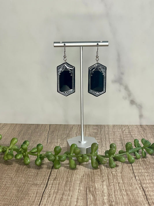 Spider web framed dangle earrings