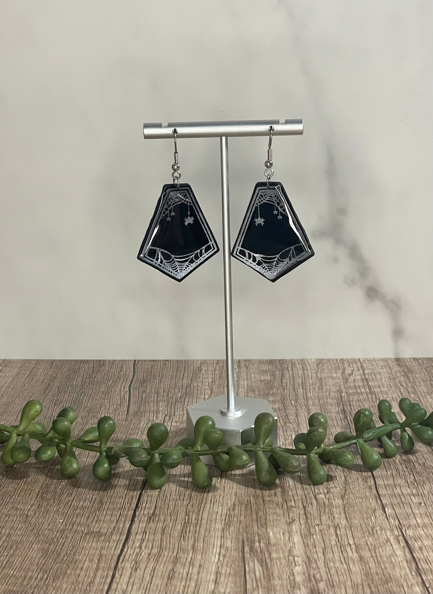 Spider web framed dangle earrings